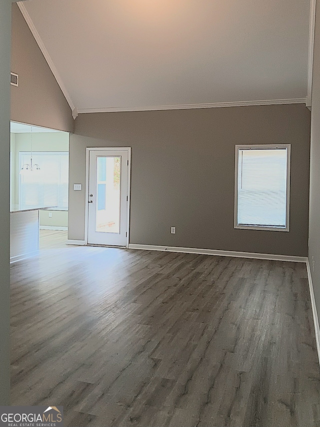 empty room featuring high vaulted ceiling, ornamental molding, an inviting chandelier, and dark hardwood / wood-style floors