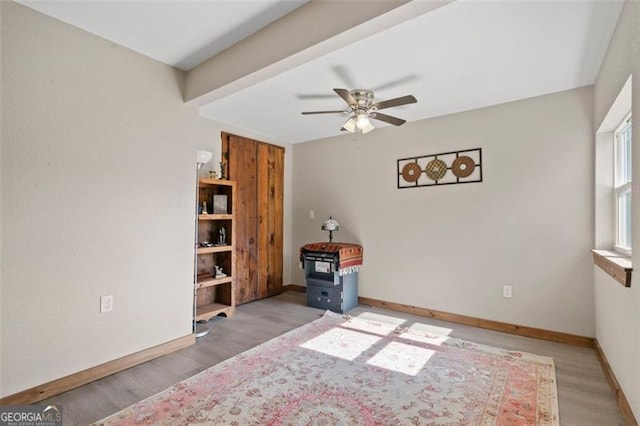 spare room featuring wood-type flooring and ceiling fan