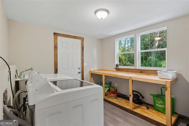 washroom with washer and dryer and light hardwood / wood-style floors