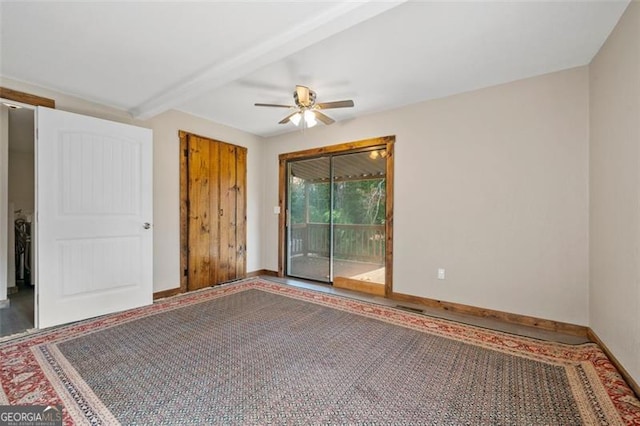 empty room with ceiling fan and beam ceiling