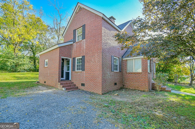 view of side of home featuring a yard