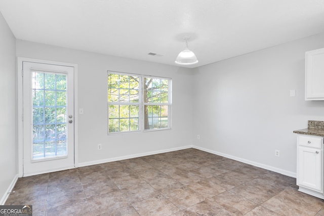 unfurnished dining area featuring a wealth of natural light