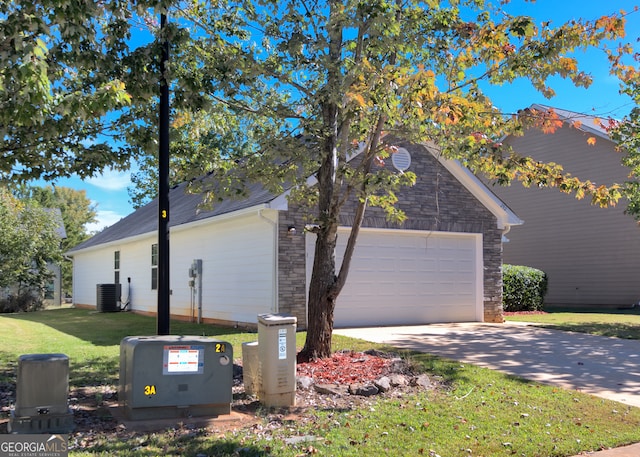 view of property exterior featuring central AC, a yard, and a garage