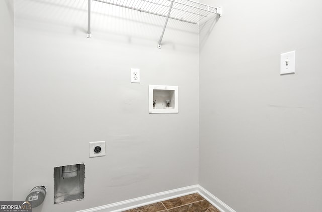 laundry room with dark tile patterned floors, hookup for an electric dryer, and washer hookup