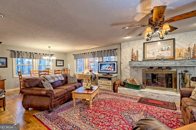 living room featuring hardwood / wood-style floors, a healthy amount of sunlight, and a textured ceiling