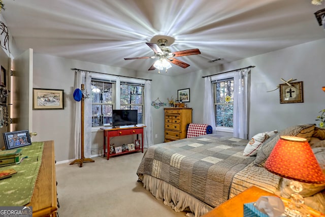 bedroom featuring ceiling fan and light carpet