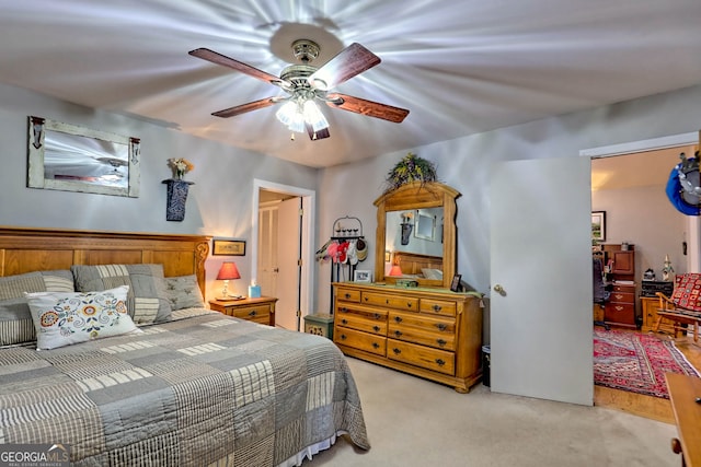 bedroom featuring light carpet and ceiling fan