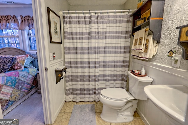 bathroom featuring tile patterned floors and toilet