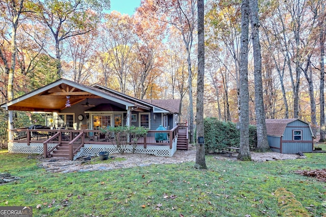 view of front of house featuring a storage unit, a deck, and a front yard