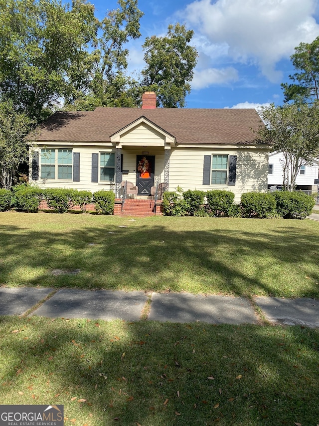 single story home featuring a front lawn