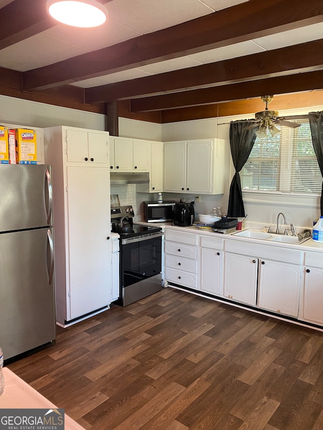 kitchen with beamed ceiling, white cabinets, stainless steel appliances, and dark hardwood / wood-style flooring