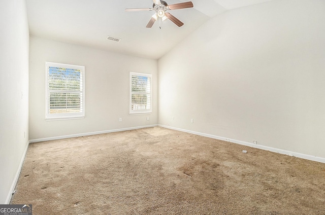 empty room featuring carpet, ceiling fan, and lofted ceiling