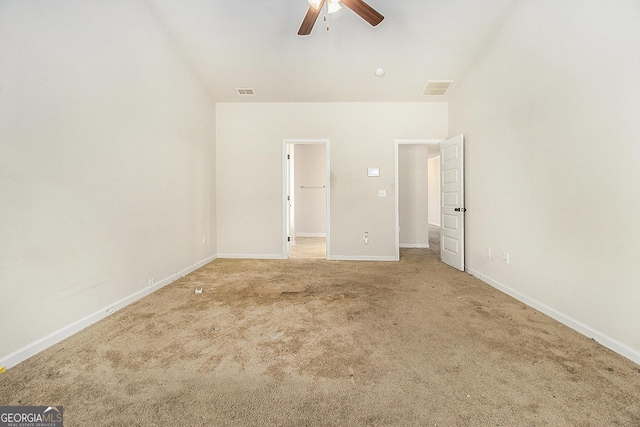 spare room featuring carpet and ceiling fan