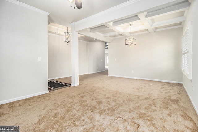 empty room featuring carpet flooring, ornamental molding, coffered ceiling, ceiling fan, and beam ceiling