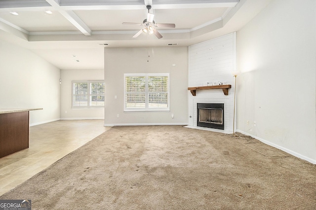 unfurnished living room featuring carpet, coffered ceiling, ceiling fan, ornamental molding, and beamed ceiling