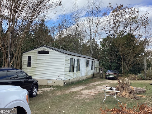 view of side of home with a yard