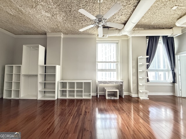 interior space with crown molding, ceiling fan, a healthy amount of sunlight, and dark hardwood / wood-style flooring