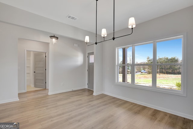 unfurnished dining area with plenty of natural light and light hardwood / wood-style flooring