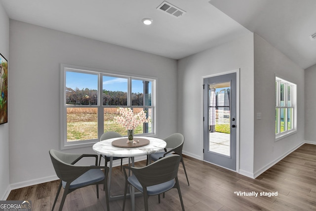 dining space with hardwood / wood-style floors