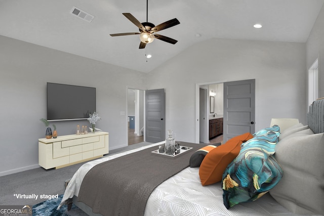 carpeted bedroom with ceiling fan, ensuite bathroom, and high vaulted ceiling