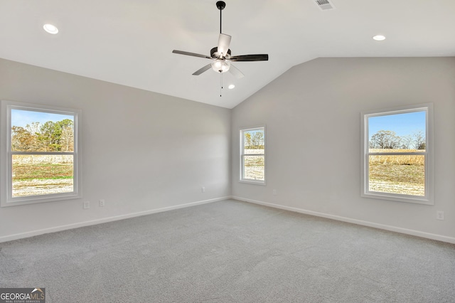 spare room featuring carpet, ceiling fan, and vaulted ceiling