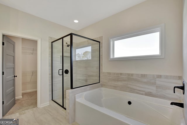 bathroom with separate shower and tub