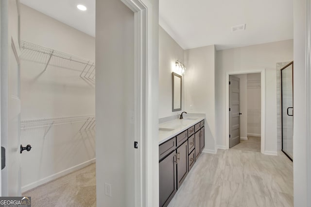 bathroom featuring vanity and an enclosed shower