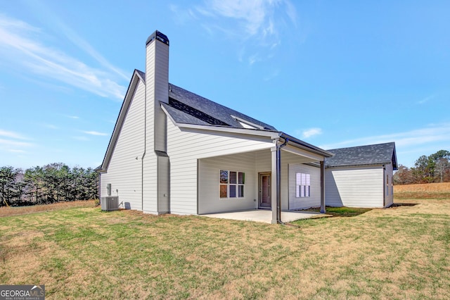 back of house with cooling unit, a yard, and a patio