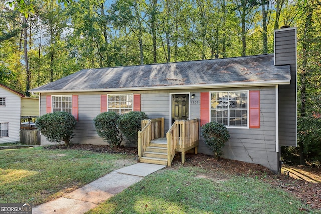 single story home with a front lawn