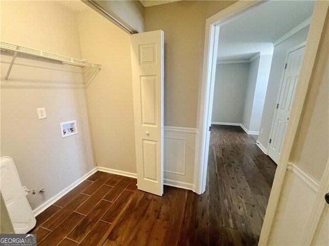 laundry room featuring dark wood-type flooring, hookup for a washing machine, and crown molding