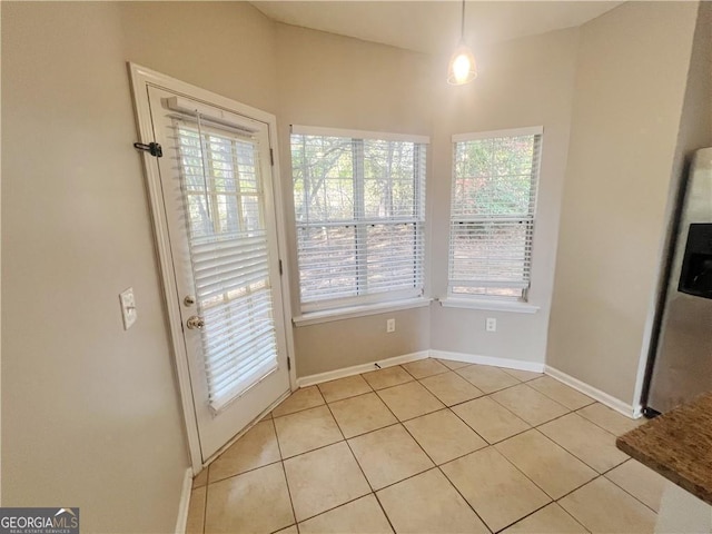 unfurnished dining area with plenty of natural light and light tile patterned floors