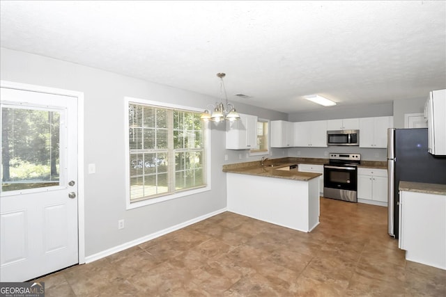 kitchen with white cabinetry, stainless steel appliances, decorative light fixtures, and kitchen peninsula