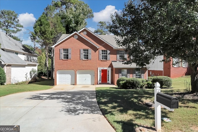 view of front of home with a front lawn and a garage