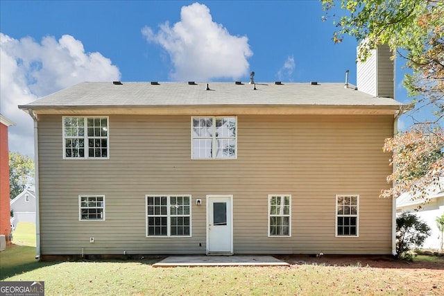 rear view of property featuring a patio and a lawn