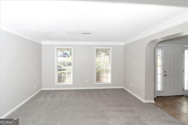 interior space featuring light carpet, a textured ceiling, and ornamental molding