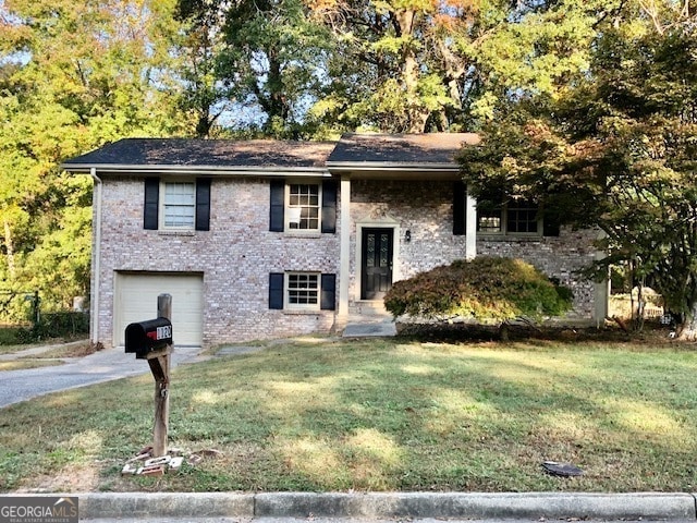 raised ranch with a front yard and a garage