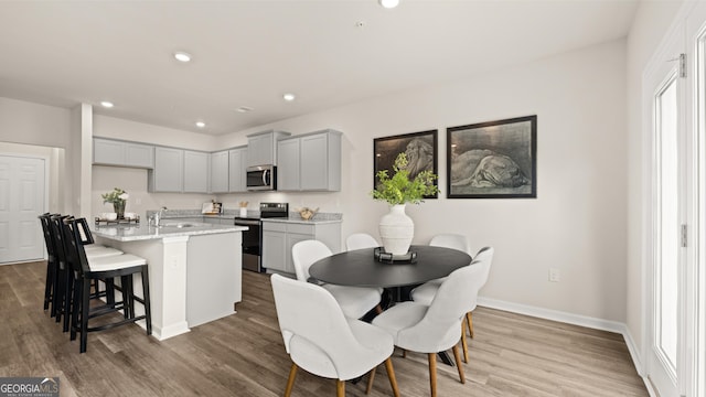 353 Sound Cir, Stockbridge, GA 30281 - dining space featuring wood finished floors, recessed lighting, and baseboards