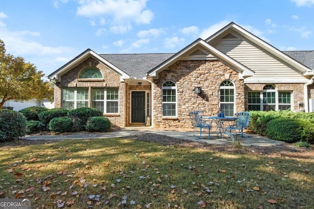 view of front of house featuring a front yard and a patio area