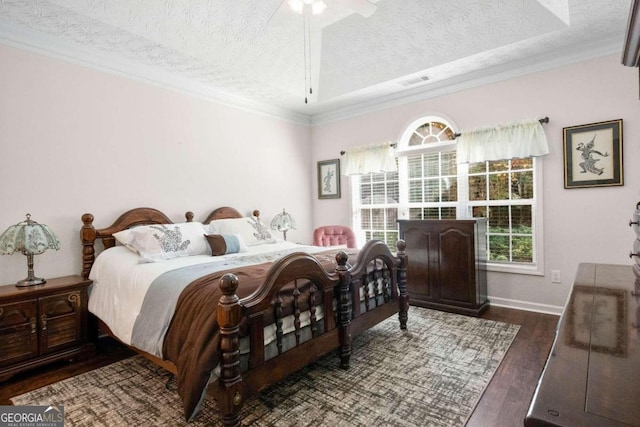 bedroom with ornamental molding, a textured ceiling, dark hardwood / wood-style floors, and ceiling fan