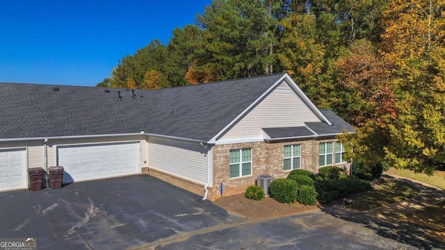 view of front of home featuring cooling unit and a garage