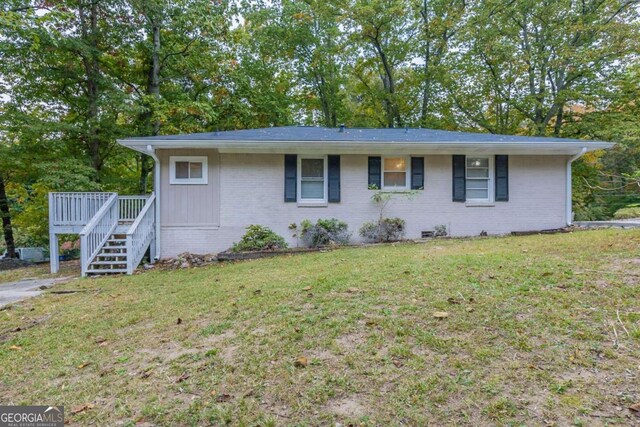 ranch-style house with a front lawn