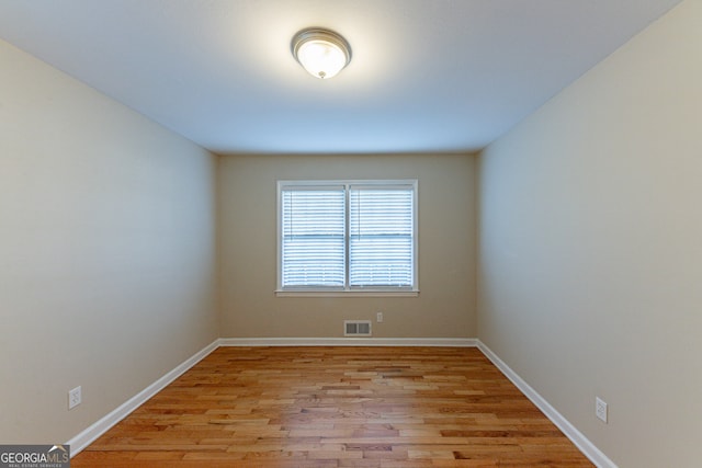 spare room with light hardwood / wood-style flooring