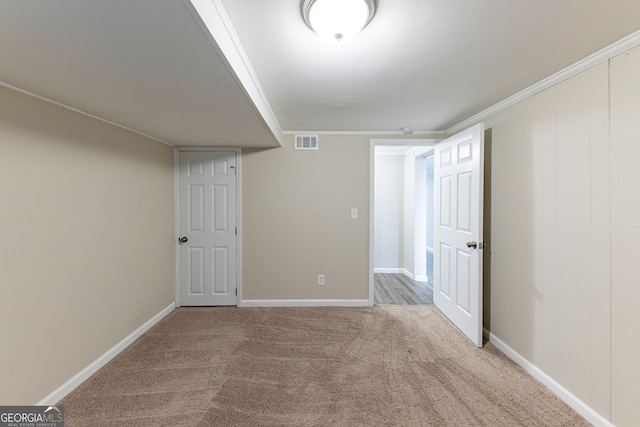 interior space with crown molding and light carpet