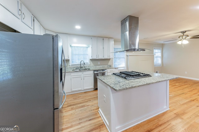 kitchen featuring white cabinetry, island exhaust hood, stainless steel appliances, and light wood-type flooring