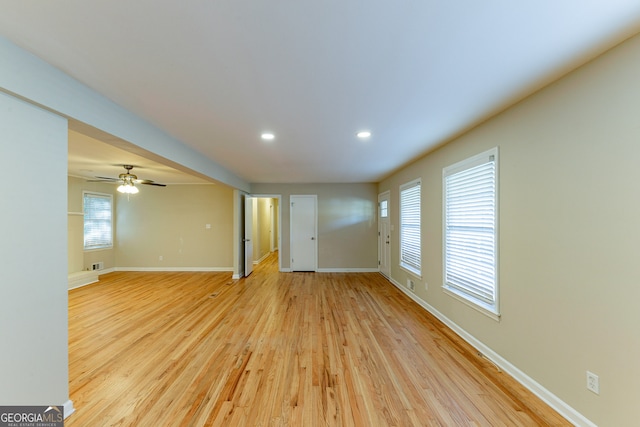 unfurnished living room featuring ceiling fan and light wood-type flooring