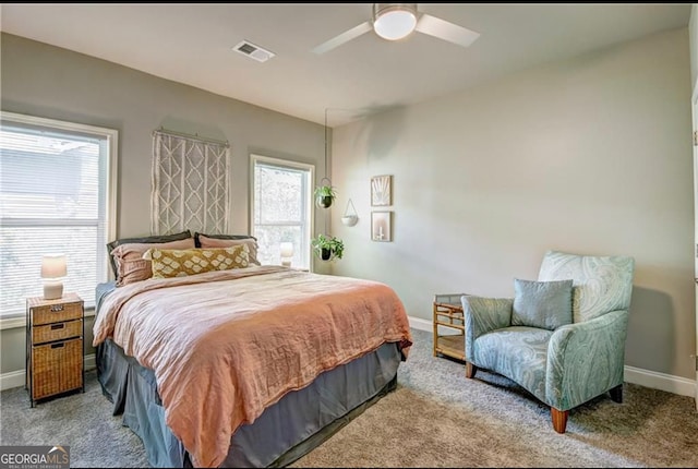 bedroom featuring light colored carpet and ceiling fan