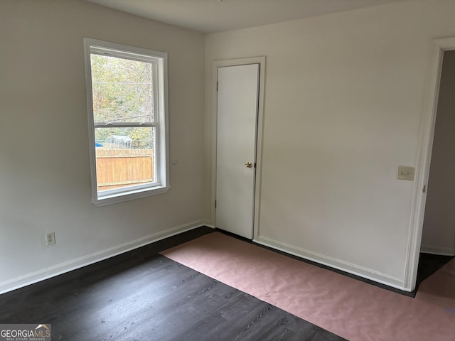 empty room featuring dark hardwood / wood-style flooring