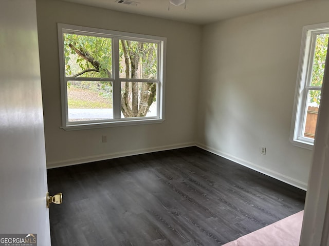 unfurnished room with ceiling fan and dark hardwood / wood-style floors