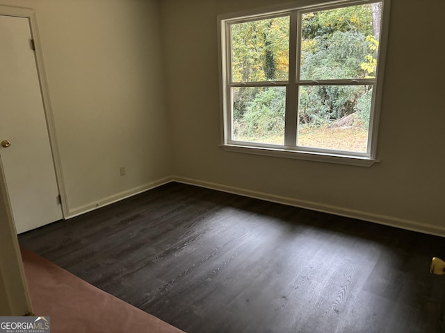 spare room with dark hardwood / wood-style floors