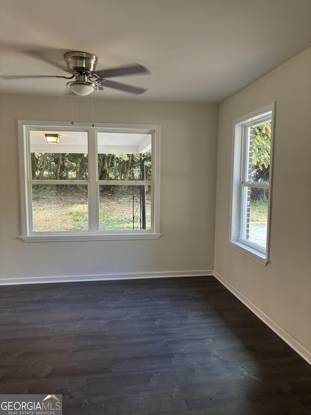 unfurnished room with dark hardwood / wood-style floors and ceiling fan